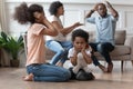 Upset african kids closing ears hurt by parents fighting