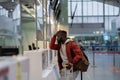 Upset African student guy in airport feeling uncertain about moving to another country