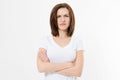 Upset and angry girl in white blank t shirt isolated on white background. Sad and mad woman with crossed arms . Copy space