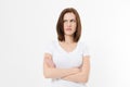 Upset and angry girl in white blank t shirt isolated on white background. Sad and mad woman with crossed arms . Copy space