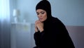 Upset arab female in hijab at home, suffering from religious discrimination