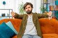 Upset arabian man showing thumbs down, dislike bad work, disapproval dissatisfied feedback at home Royalty Free Stock Photo