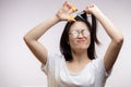 Upset Asian girl having trouble with long hair, cutting split ends with scissors Royalty Free Stock Photo