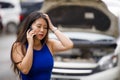 Upset Asian Korean woman in stress stranded on street suffering car engine failure having mechanic problem calling on mobile phone Royalty Free Stock Photo