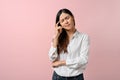 Upset Asian woman feeling unwell, having a headache on pink isolated background Royalty Free Stock Photo