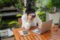 A upset Asian woman hand covering her face while holding a credit card, having financial problems Royalty Free Stock Photo