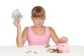 Upset baby girl with piggy bank isolated Royalty Free Stock Photo