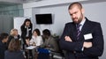 Upset bearded businessman in meeting room, working colleagues Royalty Free Stock Photo