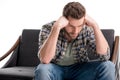 Upset bearded man sitting on sofa Royalty Free Stock Photo
