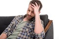 Upset bearded man sitting on sofa Royalty Free Stock Photo