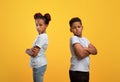 Upset black brother and sister standing back to back Royalty Free Stock Photo