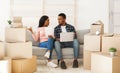 Upset black couple with laptop having problem with property documents, filing online complaint to real estate company