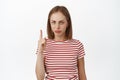 Upset blond girl pointing finger up, frowning displeased, dislike smth, express her negative opinion, unfair thing Royalty Free Stock Photo