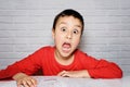 Upset boring schoolboy doing homework. Education, school, learning difficulties concept Royalty Free Stock Photo