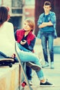 Upset boy and couple of teens apart on the street Royalty Free Stock Photo