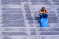 Upset boy covered his face with hands sitting on the stairs outdoors Royalty Free Stock Photo