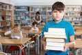 Upset boy standing with books Royalty Free Stock Photo