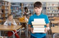 Upset boy standing with books Royalty Free Stock Photo