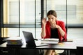 Upset caucasian accountant looking at laptop, frustrated about business failure in office