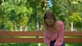 Upset caucasian woman sitting alone park bench, problem hopelessness, sadness Royalty Free Stock Photo
