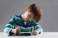 Upset child has problem with gadget. Negative emotions during online lesson. Education, online learning and gaming at home