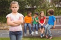 Upset child standing away from group Royalty Free Stock Photo