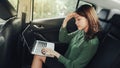 Upset confused business woman reading bad-news message, working with laptop in a car Royalty Free Stock Photo