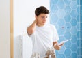 Confused young designer determining scope of work in apartment during refurbishment