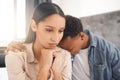 Upset couple fighting, arguing or breaking up while sitting on their bed in the bedroom at home. Sad man crying on the Royalty Free Stock Photo