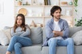 Upset Couple Sitting On Different Sides Of Couch Royalty Free Stock Photo