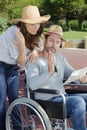 upset couple in wheelchair with map Royalty Free Stock Photo