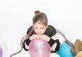 Upset crying little girl with balloons on white, grey background