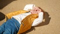 Upset crying and screaming toddler boy lying on ground at playground