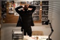 Upset detective holding his head against evidence board in despair looks stressed having problems at work, unsuccessful Royalty Free Stock Photo