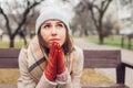 Upset devastated young woman sitting on bench in autumn park crying and praying. Mental health and religion Royalty Free Stock Photo