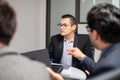 upset directive young businessman in work meeting, hispanic man focused in work at the office, team co-work space discussing Royalty Free Stock Photo