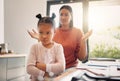 Upset, discipline and family while offended and stubborn little girl looking unhappy with her scolding mother in the Royalty Free Stock Photo