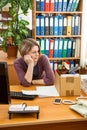 Upset dismissed young woman employee with packing box at workplace on last working day, frustrated office worker preparing to