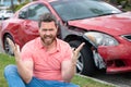 Upset driver man in front of automobile crash car collision accident. Royalty Free Stock Photo