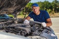 Upset driver man in front of old automobile crash car collision accident in city road Royalty Free Stock Photo