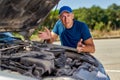 Upset driver man in front of old automobile crash car collision accident in city road Royalty Free Stock Photo