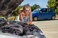 Upset driver woman in front of automobile broken car collision accident at city road Royalty Free Stock Photo