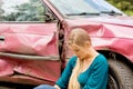 Upset driver woman in front of automobile crash car.