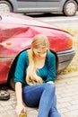 Upset driver woman in front of automobile crash car.