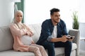 Upset Expectant Muslim Woman Sitting Offended To Husband That Playing Video Games Royalty Free Stock Photo