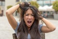 Upset frantic young woman tearing at her hair Royalty Free Stock Photo