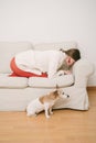 Upset frustrated girl in red pantyhose curled up on the couch Royalty Free Stock Photo