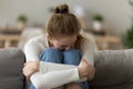 Upset frustrated woman sitting on couch, embrace knees, having problem Royalty Free Stock Photo