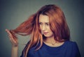 Upset frustrated young woman surprised she is losing hair, noticed split ends Royalty Free Stock Photo