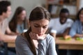 Upset frustrated woman sitting alone, suffering from bullying